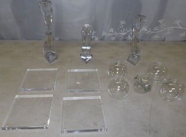 lot of glass candlesticks and oil lamps