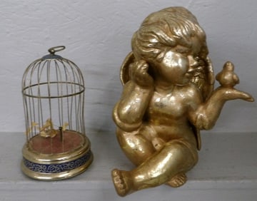 gilded ceramic angel in bird cage