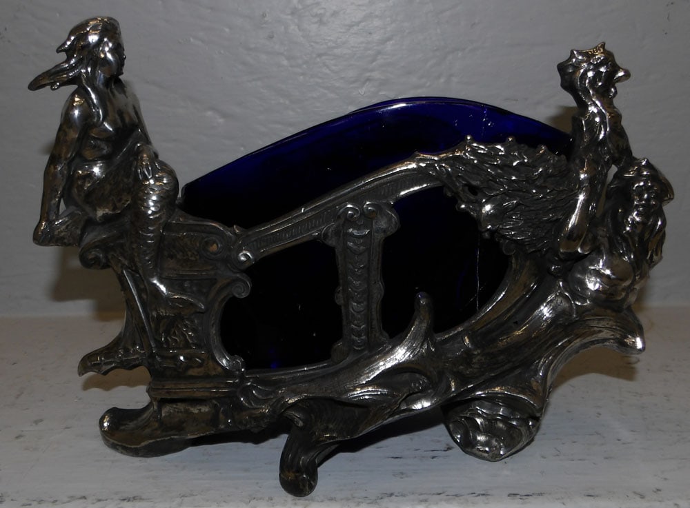 heavy nautical mermaid silverplate and cobalt blue glass line planter: heavy nautical mermaid silverplate and cobalt blue glass line planter. 12" W 8" H "ALL DESCRIPTIONS AND ANY CONDITION STATEMENT GIVEN BY LANGSTON AUCTION GALLERY ARE STRICTLY OPINIONS AND LANGSTON'S S