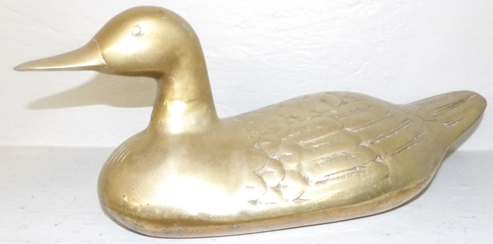 brass duck decoy: brass duck decoy. 16 1/2" L "ALL DESCRIPTIONS AND ANY CONDITION STATEMENT GIVEN BY LANGSTON AUCTION GALLERY ARE STRICTLY OPINIONS AND LANGSTON'S SHALL HAVE NO RESPONSIBILITY FOR ERRORS OR OMISSIONS. T