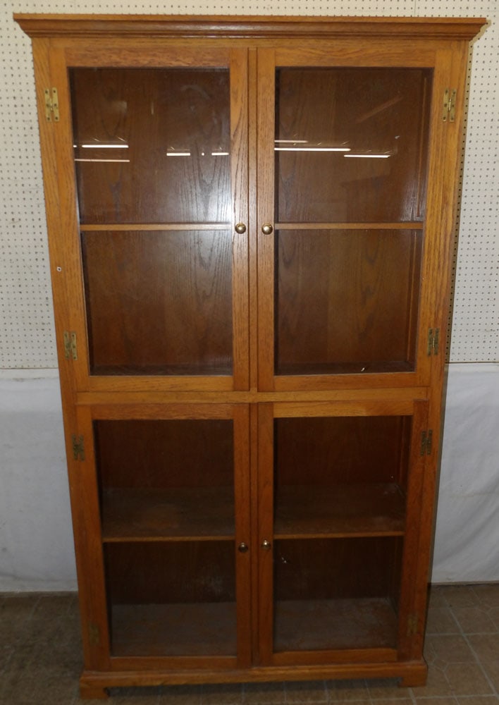 Oak Four Door Glass Cabinet: Oak Four Door Glass Cabinet . 50 1/2" W 16" D 87 3/4" H ALL DESCRIPTIONS AND ANY CONDITION STATEMENT GIVEN BY LANGSTON AUCTION GALLERY ARE STRICTLY OPINIONS AND LANGSTON'S SHALL HAVE NO RESPONSIBILITY