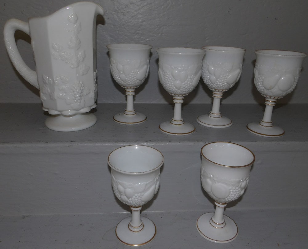 Milk Glass Pitcher & Six Goblets: Milk Glass Pitcher & Six Goblets . Up to 9" H ALL DESCRIPTIONS AND ANY CONDITION STATEMENT GIVEN BY LANGSTON AUCTION GALLERY ARE STRICTLY OPINIONS AND LANGSTON'S SHALL HAVE NO RESPONSIBILITY FOR ERROR