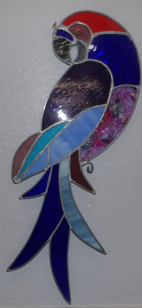 Leaded Stain Glass Parrot Sun Catcher: Leaded Stain Glass Parrot Sun Catcher . 14 1/2" W 24 3/4" H ALL DESCRIPTIONS AND ANY CONDITION STATEMENT GIVEN BY LANGSTON AUCTION GALLERY ARE STRICTLY OPINIONS AND LANGSTON'S SHALL HAVE NO RESPONSIBI