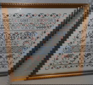 framed needlework sampler