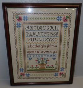 framed needlework sampler
