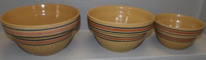 three pottery mixing bowls