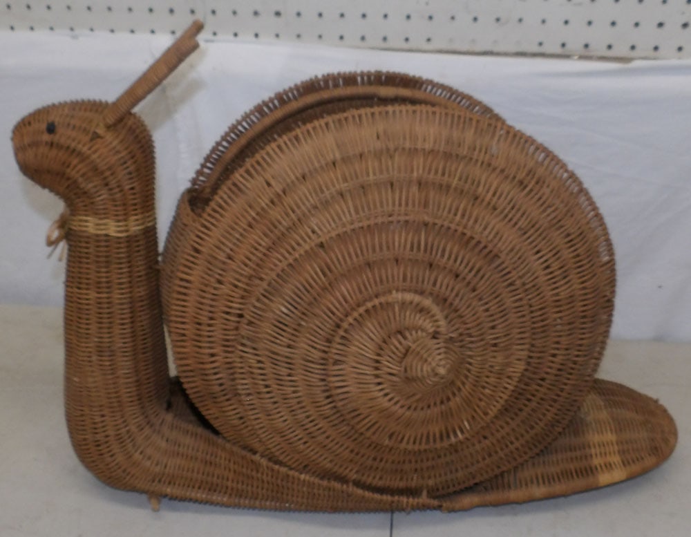 snail form wicker basket: snail form wicker basket. 23 1/2" L 16 1/2" H "ALL DESCRIPTIONS AND ANY CONDITION STATEMENT GIVEN BY LANGSTON AUCTION GALLERY ARE STRICTLY OPINIONS AND LANGSTON'S SHALL HAVE NO RESPONSIBILITY FOR ERRO