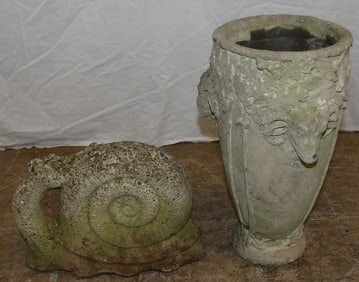 concrete planter with ram's head handle and concrete snail statue