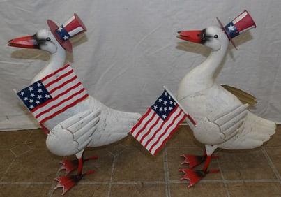 two painted metal ducks