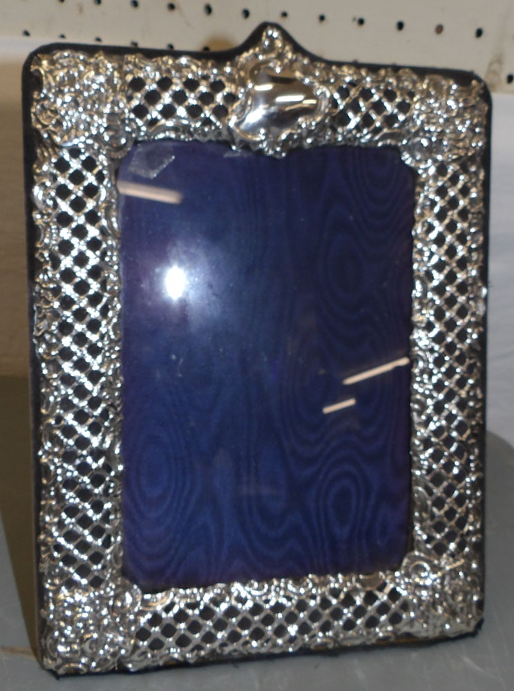 Ornate Sterling Hallmarked Frame: Ornate Sterling Hallmarked Frame. 8 1/2" x 11 1/2" "ALL DESCRIPTIONS AND ANY CONDITION STATEMENT GIVEN BY LANGSTON AUCTION GALLERY ARE STRICTLY OPINIONS AND LANGSTON'S SHALL HAVE NO RESPONSIBILITY FOR