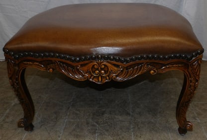 carved walnut and leather upholstered ottoman by Theodore Alexander