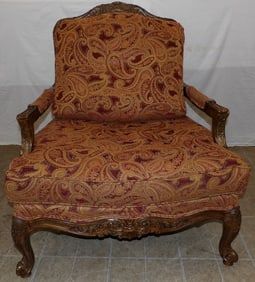 carved walnut and upholstered over sized French arm chair