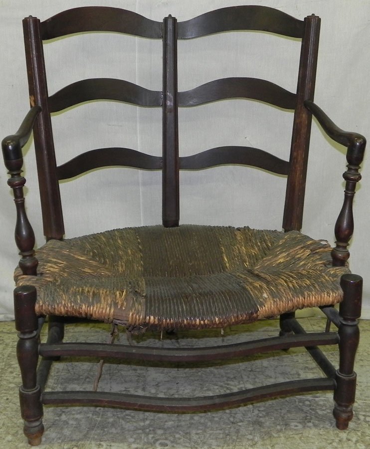Early walnut rush seat ladder back settee.: Early walnut rush seat ladder back settee.