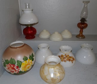 lot of glass oil lamps and lamp shades