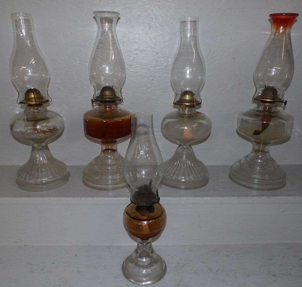 5 antique glass oil lamps: 5 antique glass oil lamps. Up to 18 1/2" H 5 3/4" Dia. ALL DESCRIPTIONS AND ANY CONDITION STATEMENT GIVEN BY LANGSTON AUCTION GALLERY ARE STRICTLY OPINIONS AND LANGSTON'S SHALL HAVE NO RESPONSIBILITY 