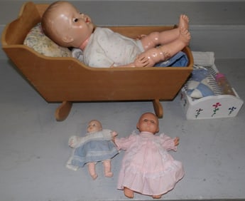 lot of dolls and doll cradle