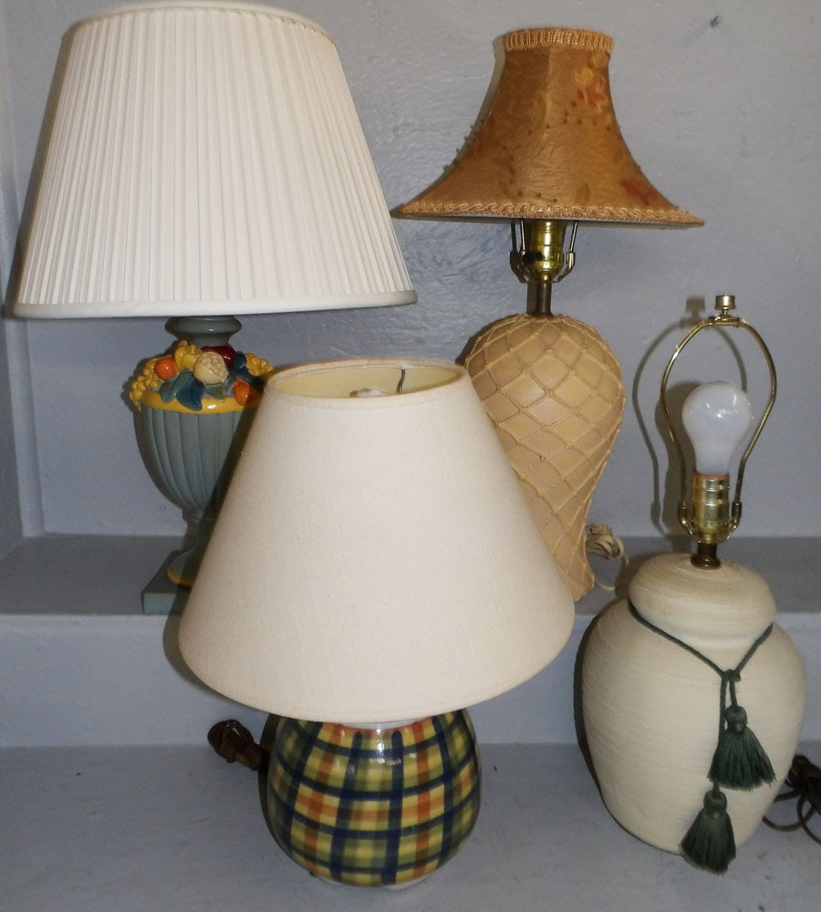 lot of four ceramic and pottery lamps : lot of four ceramic and pottery lamps . 23 1/2" H 15" Dia. ALL DESCRIPTIONS AND ANY CONDITION STATEMENT GIVEN BY LANGSTON AUCTION GALLERY ARE STRICTLY OPINIONS AND LANGSTON'S SHALL HAVE NO RESPONSIBIL