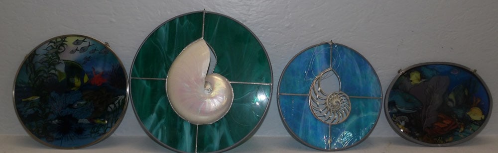 Four Stained Glass Sun Catchers : Four Stained Glass Sun Catchers . Up to 11 1/2" Dia. ALL DESCRIPTIONS AND ANY CONDITION STATEMENT GIVEN BY LANGSTON AUCTION GALLERY ARE STRICTLY OPINIONS AND LANGSTON'S SHALL HAVE NO RESPONSIBILITY FO