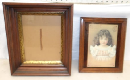 framed advertisement and antique walnut frame