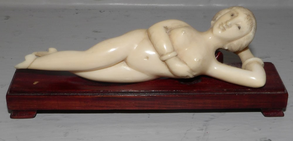 Carved Bone Nude Woman on Teakwood Stand : Carved Bone Nude Woman on Teakwood Stand . 2" H 5 1/4" W 1 1/4" D