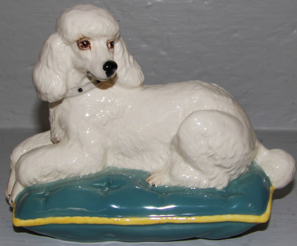 Royal Doulton Figure of Poodle Resting on Pillow: Royal Doulton Figure of Poodle Resting on Pillow. 5 1/4" H 6 3/4" W 4" D