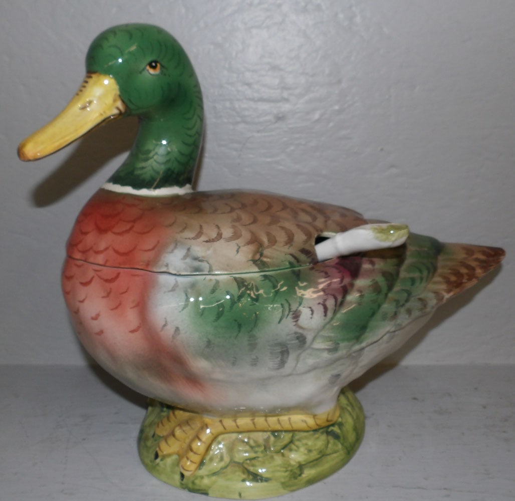 Painted Porcelain Duck Form Tureen: Painted Porcelain Duck Form Tureen . 13" H 14 1/2" W 7" D ALL DESCRIPTIONS AND ANY CONDITION STATEMENT GIVEN BY LANGSTON AUCTION GALLERY ARE STRICTLY OPINIONS AND LANGSTON'S SHALL HAVE NO RESPONSIBILI