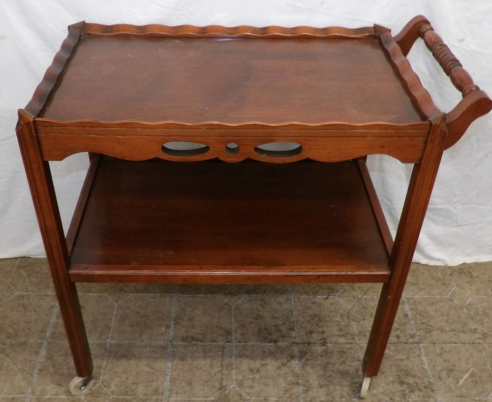 Mahogany Rolling Tea Cart: Mahogany Rolling Tea Cart . 27 3/4" H 16 1/4" W 29" D ALL DESCRIPTIONS AND ANY CONDITION STATEMENT GIVEN BY LANGSTON AUCTION GALLERY ARE STRICTLY OPINIONS AND LANGSTON'S SHALL HAVE NO RESPONSIBILITY F