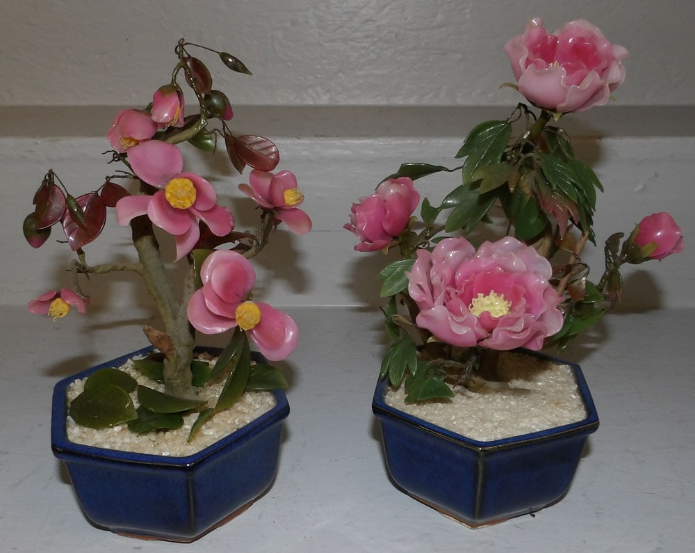 Two Carved Stone Oriental Plants in Pottery Jardinieres: Two Carved Stone Oriental Plants in Pottery Jardinieres. 9 1/2" H 6" Dia. ALL DESCRIPTIONS AND ANY CONDITION STATEMENT GIVEN BY LANGSTON AUCTION GALLERY ARE STRICTLY OPINIONS AND LANGSTON'S SHALL HAVE