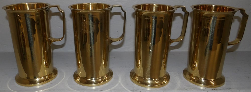 Set of Four Brass Mugs: Set of Four Brass Mugs . 7 1/4" H 4 3/4" Dia. ALL DESCRIPTIONS AND ANY CONDITION STATEMENT GIVEN BY LANGSTON AUCTION GALLERY ARE STRICTLY OPINIONS AND LANGSTON'S SHALL HAVE NO RESPONSIBILITY FOR ERROR