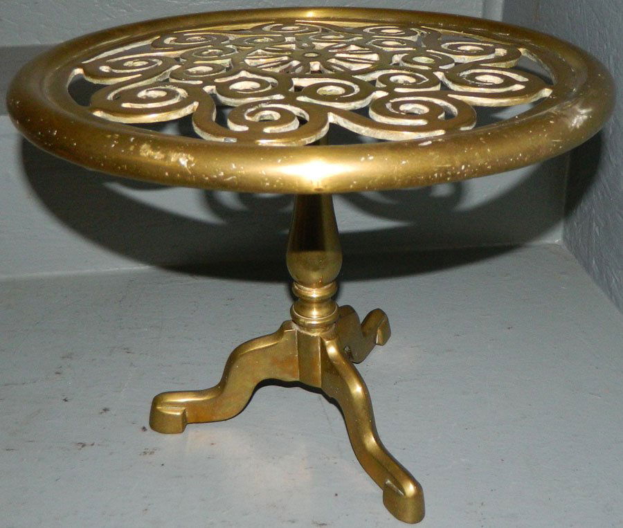 Rotating brass trivet.: Rotating brass trivet. 10" tall.