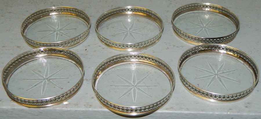 Six sterling coasters with cut glass bottoms.: Six sterling coasters with cut glass bottoms.