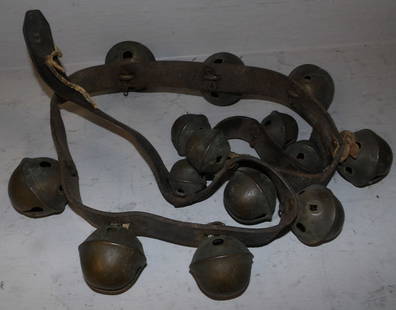 antique brass and leather strap sleigh bells: antique brass and leather strap sleigh bells. 54 1/2" L ALL DESCRIPTIONS AND ANY CONDITION STATEMENT GIVEN BY LANGSTON AUCTION GALLERY ARE STRICTLY OPINIONS AND LANGSTON'S SHALL HAVE NO RESPONSIBILITY