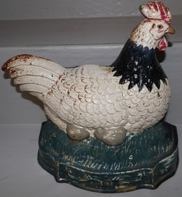 painted cast iron hen on the nest door stop