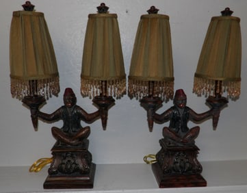 pair of painted resin monkey lamps