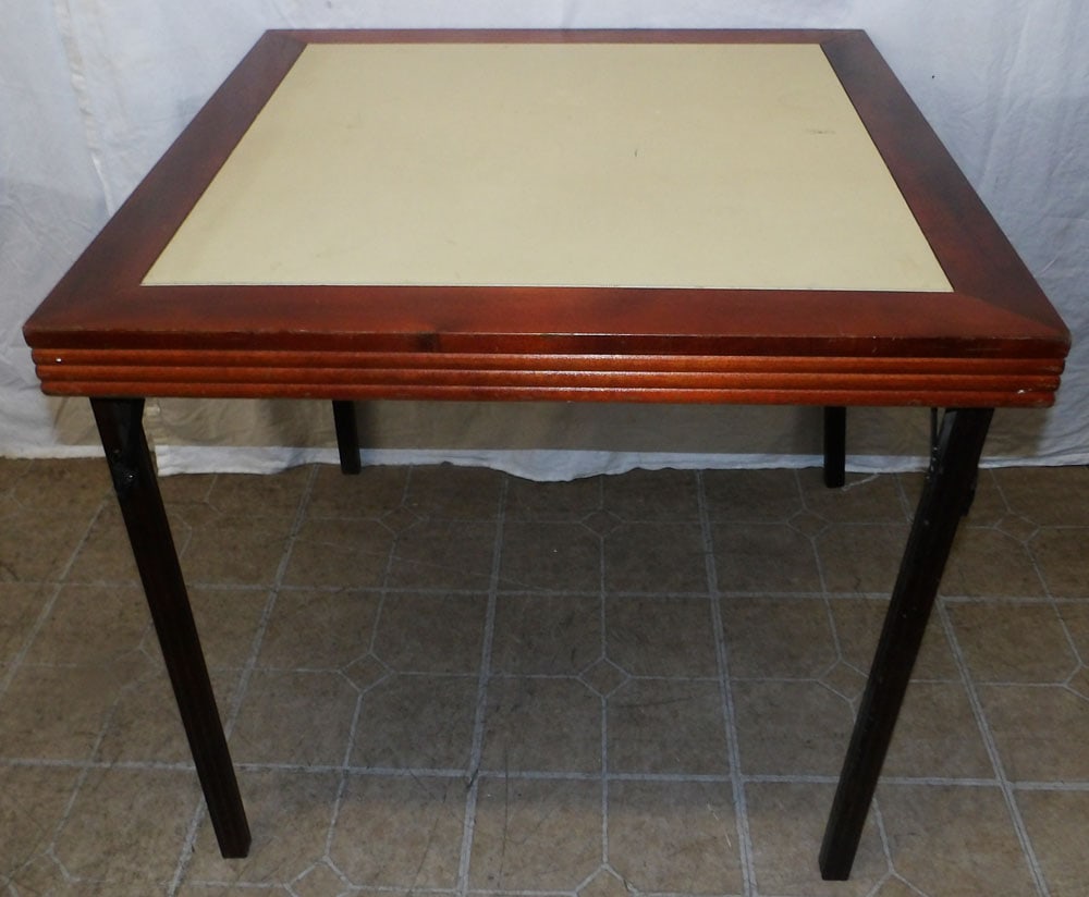 mahogany and faux leather folding card table: mahogany and faux leather folding card table . 27" H 30" Dia. ALL DESCRIPTIONS AND ANY CONDITION STATEMENT GIVEN BY LANGSTON AUCTION GALLERY ARE STRICTLY OPINIONS AND LANGSTON'S SHALL HAVE NO RESPONSI
