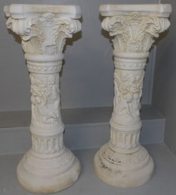pair of ceramic pedestals with cherub motif