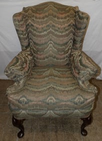 carved mahogany and upholstered wingback chair