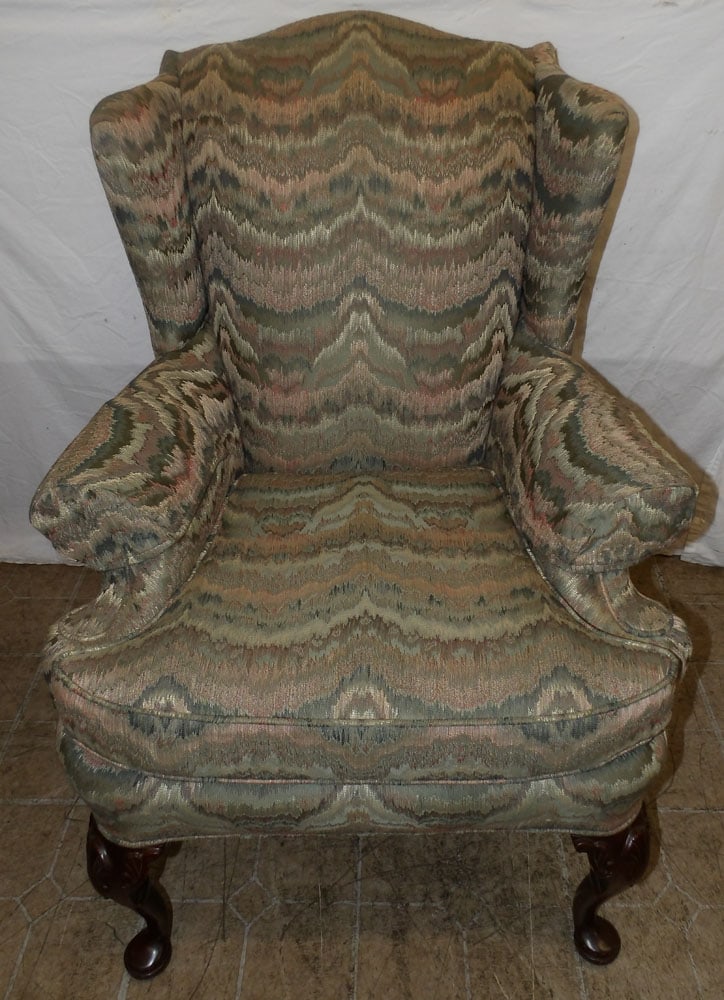 carved mahogany and upholstered wingback chair: carved mahogany and upholstered wingback chair . 40 1/2" H 30" W 27" D ALL DESCRIPTIONS AND ANY CONDITION STATEMENT GIVEN BY LANGSTON AUCTION GALLERY ARE STRICTLY OPINIONS AND LANGSTON'S SHALL HAVE NO