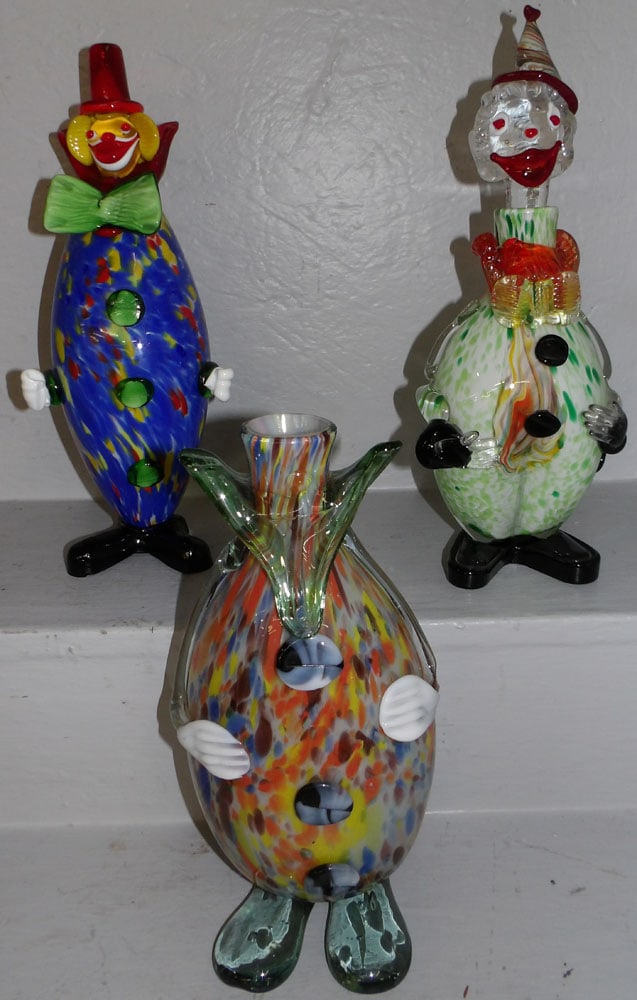 Three Art Glass Clown Form Decanters: Three Art Glass Clown Form Decanters. Up to 14 3/4" H 6 1/4" Dia. ALL DESCRIPTIONS AND ANY CONDITION STATEMENT GIVEN BY LANGSTON AUCTION GALLERY ARE STRICTLY OPINIONS AND LANGSTON'S SHALL HAVE NO RESP