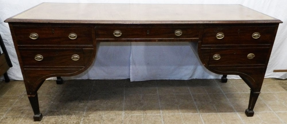 19th century mahogany tooled leather top desk: 19th century mahogany tooled leather top desk. 30" H 67 1/2" W 25" D ALL DESCRIPTIONS AND ANY CONDITION STATEMENT GIVEN BY LANGSTON AUCTION GALLERY ARE STRICTLY OPINIONS AND LANGSTON'S SHALL HAVE NO R
