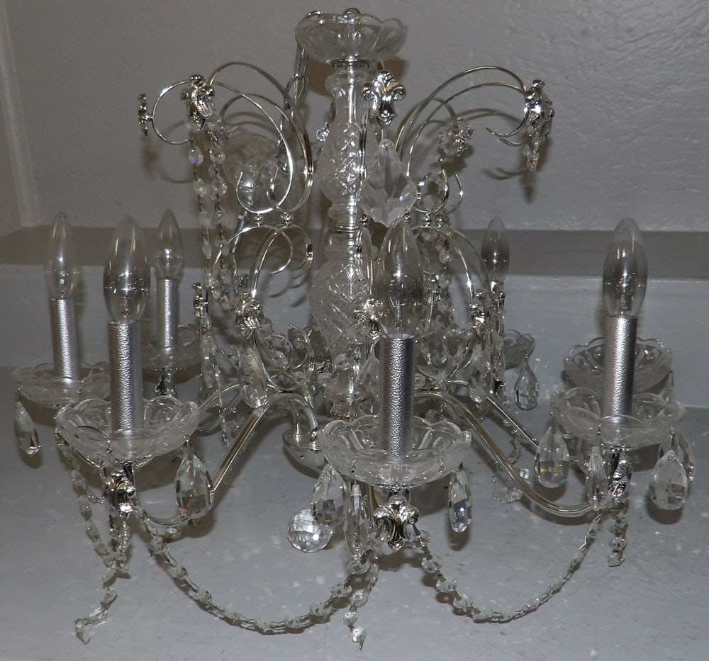 metal and crystal 8 light chandelier with glass prisms: metal and crystal 8 light chandelier with glass prisms . 18"H 24"Dia. ALL DESCRIPTIONS AND ANY CONDITION STATEMENT GIVEN BY LANGSTON AUCTION GALLERY ARE STRICTLY OPINIONS AND LANGSTON'S SHALL HAVE NO