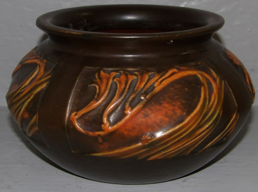 Roseville rose craft panel pottery jardiniere: Roseville rose craft panel pottery jardiniere. 4" H 7" Dia. ALL DESCRIPTIONS AND ANY CONDITION STATEMENT GIVEN BY LANGSTON AUCTION GALLERY ARE STRICTLY OPINIONS AND LANGSTON'S SHALL HAVE NO RESPONSIBI