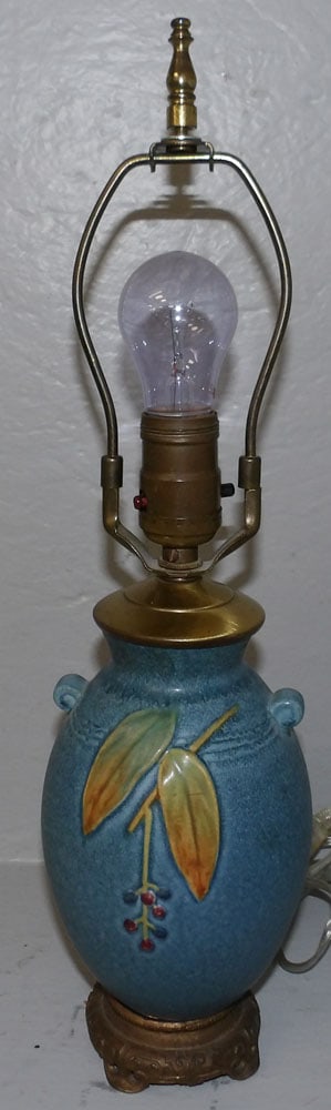 Weller pottery vase made into lamp: Weller pottery vase made into lamp. 17 3/4" H 4 1/2" Dia. ALL DESCRIPTIONS AND ANY CONDITION STATEMENT GIVEN BY LANGSTON AUCTION GALLERY ARE STRICTLY OPINIONS AND LANGSTON'S SHALL HAVE NO RESPONSIBILI
