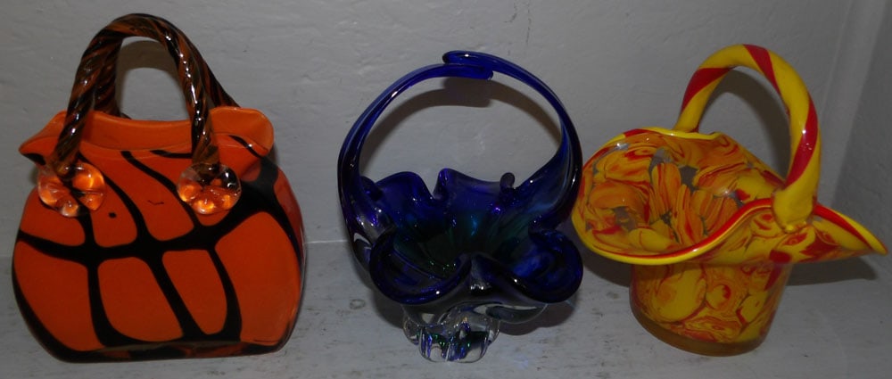 three art glass baskets: three art glass baskets. up to 8" H and 8" Dia. ALL DESCRIPTIONS AND ANY CONDITION STATEMENT GIVEN BY LANGSTON AUCTION GALLERY ARE STRICTLY OPINIONS AND LANGSTON'S SHALL HAVE NO RESPONSIBILITY FOR ERR