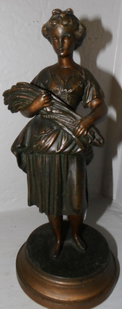 Antique Painted Spelter Sculpture of Lady Carrying Wheat: Antique Painted Spelter Sculpture of Lady Carrying Wheat . 10" H 4 1/4" Dia. ALL DESCRIPTIONS AND ANY CONDITION STATEMENT GIVEN BY LANGSTON AUCTION GALLERY ARE STRICTLY OPINIONS AND LANGSTON'S SHALL H