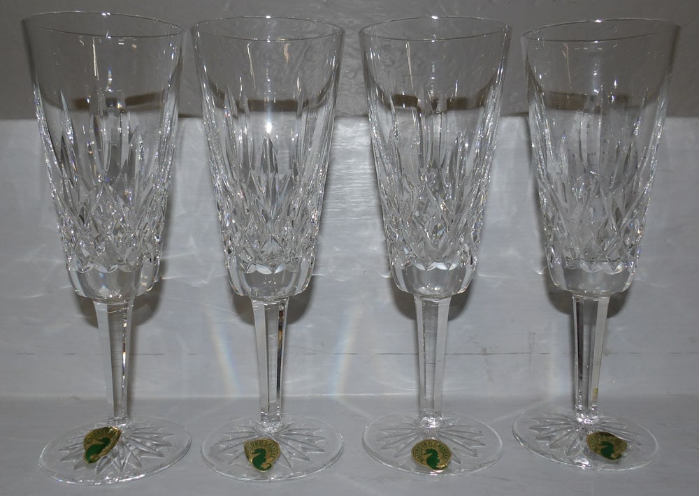 Four Waterford Crystal Champagne Glasses: Four Waterford Crystal Champagne Glasses. 7 1/4" H 2 1/2" Dia. ALL DESCRIPTIONS AND ANY CONDITION STATEMENT GIVEN BY LANGSTON AUCTION GALLERY ARE STRICTLY OPINIONS AND LANGSTON'S SHALL HAVE NO RESPONS