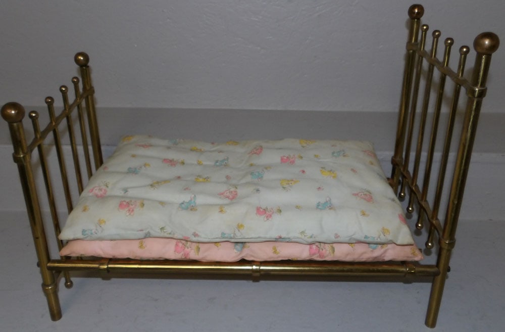 brass doll bed: brass doll bed . 17" H 11" W 23" D ALL DESCRIPTIONS AND ANY CONDITION STATEMENT GIVEN BY LANGSTON AUCTION GALLERY ARE STRICTLY OPINIONS AND LANGSTON'S SHALL HAVE NO RESPONSIBILITY FOR ERRORS OR OMISSI