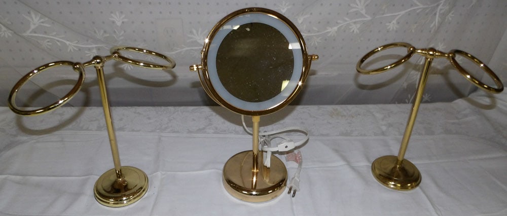Lot Two Brass Dresser Stands & Mirror: Lot Two Brass Dresser Stands & Mirror. Up to 15" H 7 1/2" W 5" D ALL DESCRIPTIONS AND ANY CONDITION STATEMENT GIVEN BY LANGSTON AUCTION GALLERY ARE STRICTLY OPINIONS AND LANGSTON'S SHALL HAVE NO RESPO
