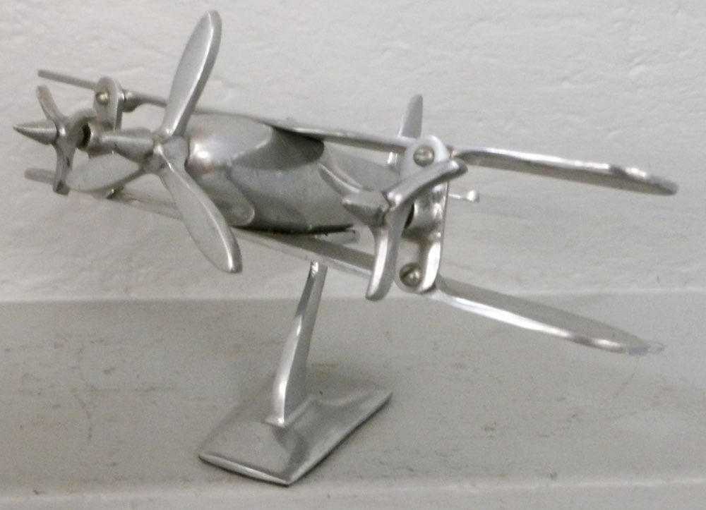 Aluminum Airplane Model: Aluminum Airplane Model. 7 1/2" H 10 1/2" W 12 1/2" D ALL DESCRIPTIONS AND ANY CONDITION STATEMENT GIVEN BY LANGSTON AUCTION GALLERY ARE STRICTLY OPINIONS AND LANGSTON'S SHALL HAVE NO RESPONSIBILITY F