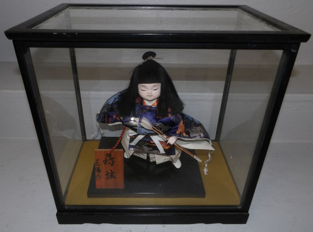 Oriental Porcelain Doll In Glass Case: Oriental Porcelain Doll In Glass Case. 14 1/2" H 14 3/4" W 10" D ALL DESCRIPTIONS AND ANY CONDITION STATEMENT GIVEN BY LANGSTON AUCTION GALLERY ARE STRICTLY OPINIONS AND LANGSTON'S SHALL HAVE NO RESPO
